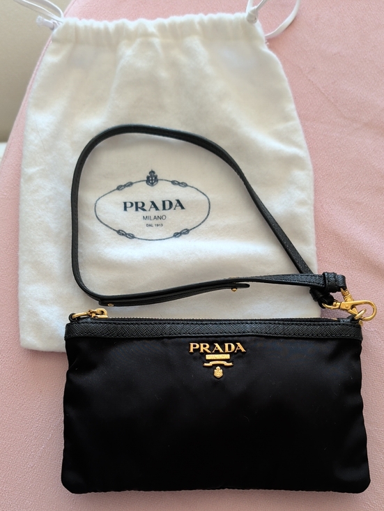 Prada Handbags - Prada Black Nylon Wrist Pouch with Gold Logo. Brand new. Bought In Milan.